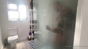 Muscular man showering in slow motion