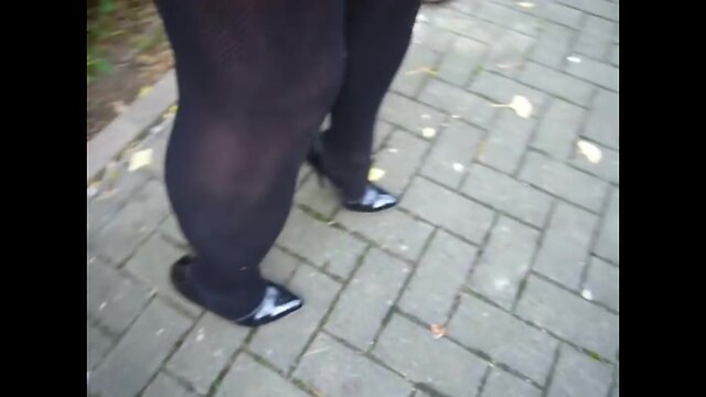 Walking in black patent leather high heels